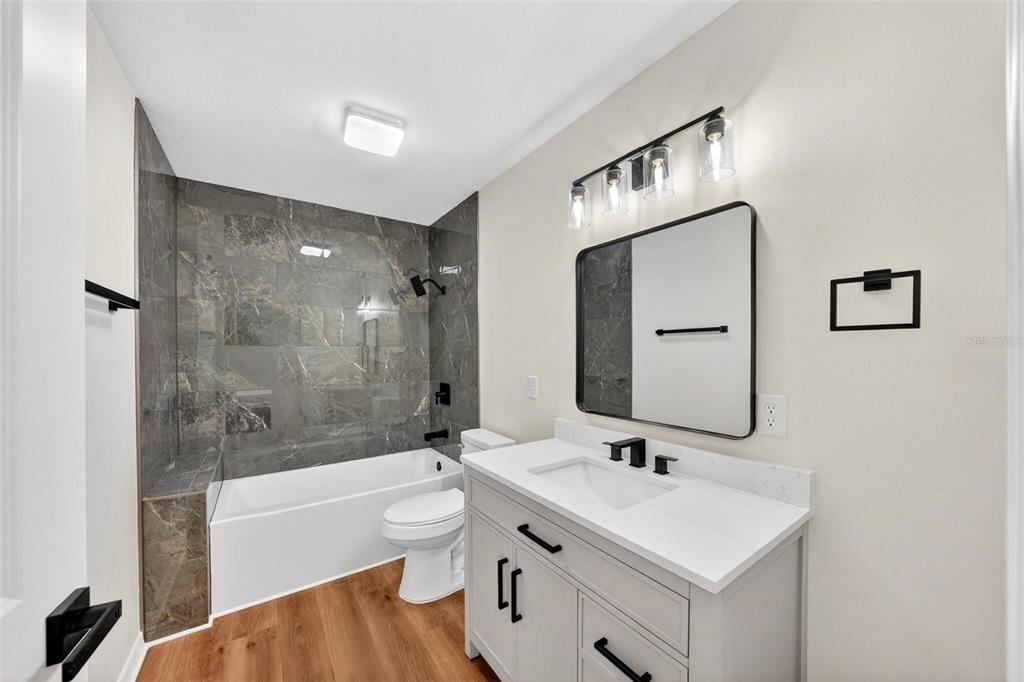 607 Thomas Avenue Leesburg, FL 34748 - Photo 19 of 50 a bathroom with a sink a toilet and shower