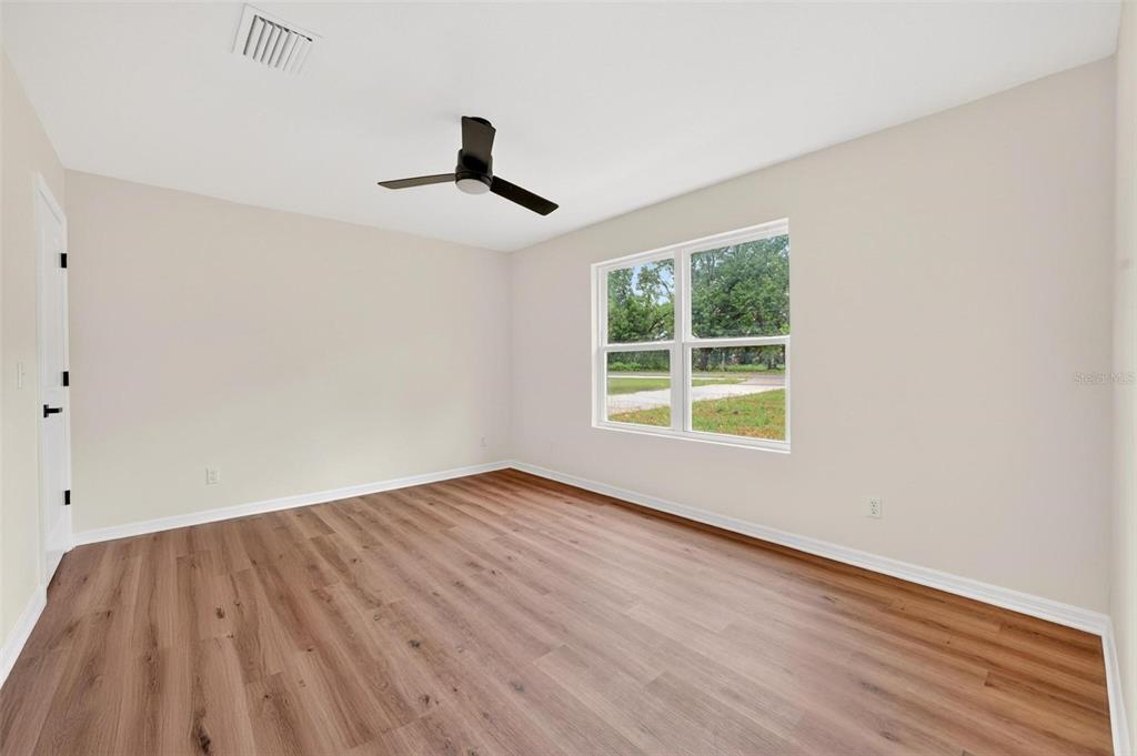 607 Thomas Avenue Leesburg, FL 34748 - Photo 20 of 50 wooden floor in an empty room with a window