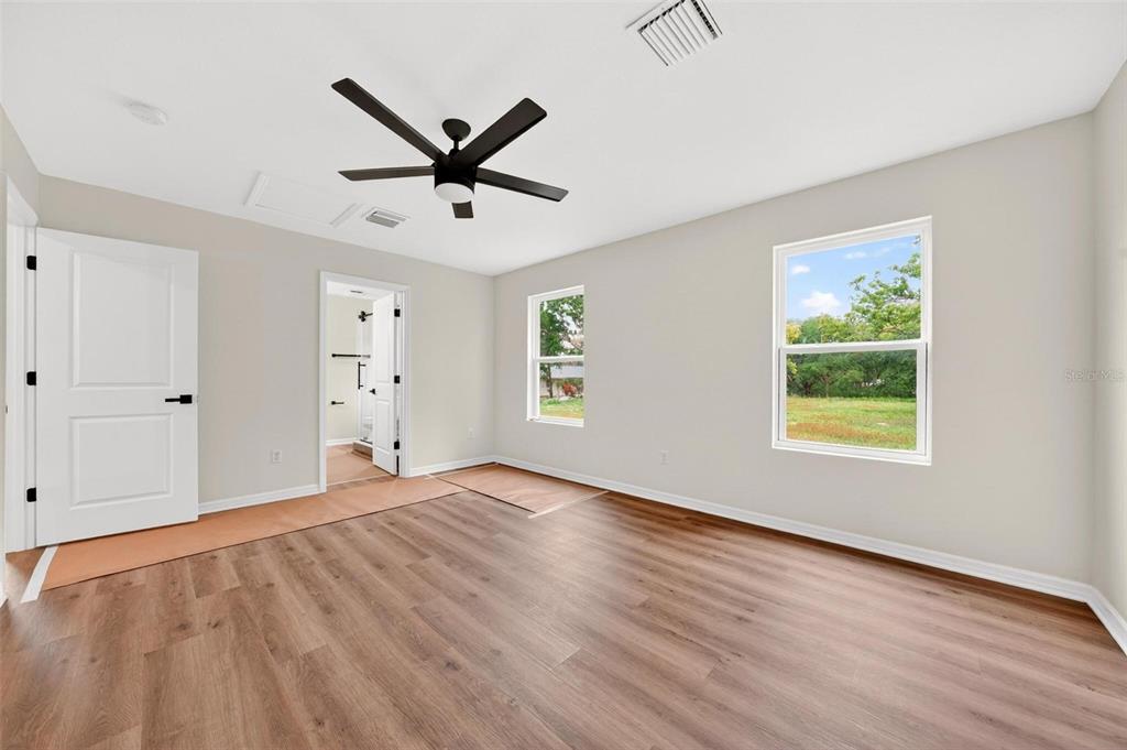607 Thomas Avenue Leesburg, FL 34748 - Photo 24 of 50 a view of an empty room with window and wooden floor