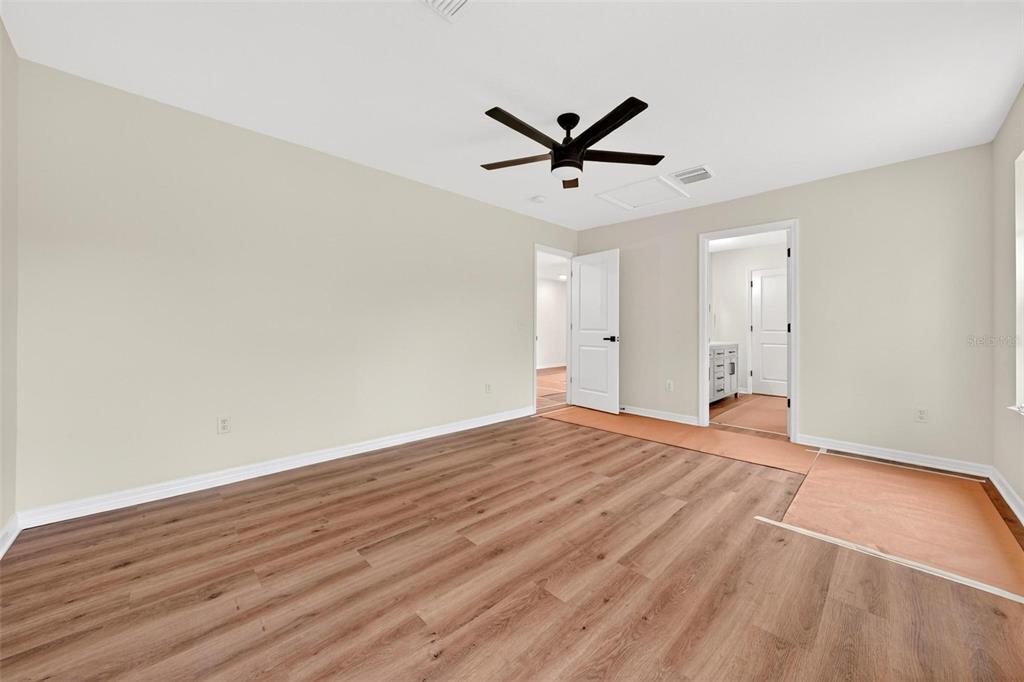 607 Thomas Avenue Leesburg, FL 34748 - Photo 25 of 50 a view of empty room with wooden floor and fan