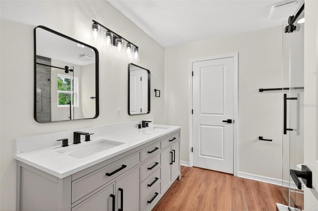 607 Thomas Avenue Leesburg, FL 34748 - Photo 26 of 50 a bathroom with a double vanity sink mirror and