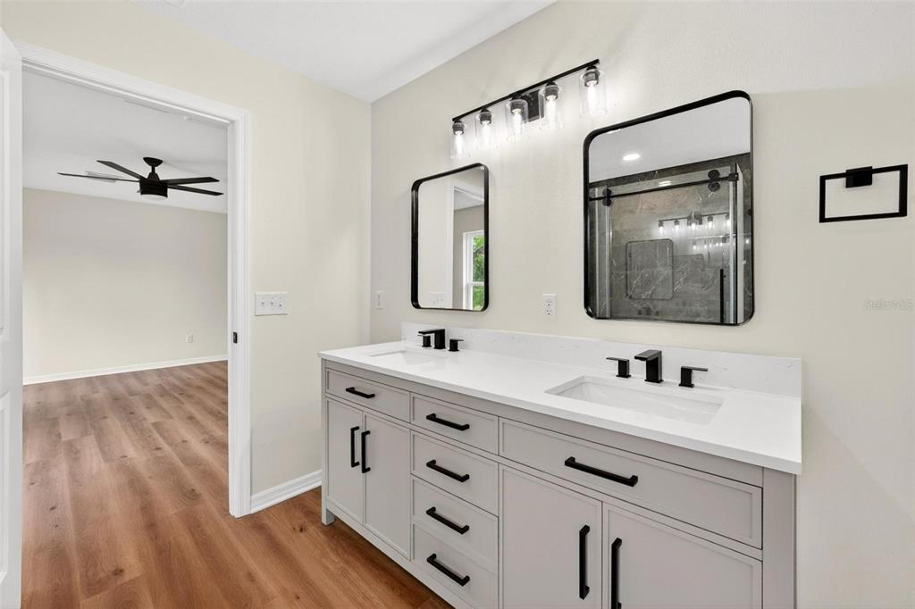 607 Thomas Avenue Leesburg, FL 34748 - Photo 28 of 50 a bathroom with a double vanity sink mirror and