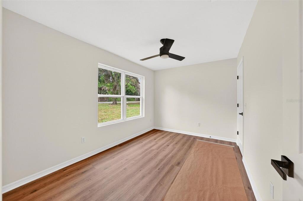 607 Thomas Avenue Leesburg, FL 34748 - Photo 34 of 50 a view of empty room with wooden floor and fan