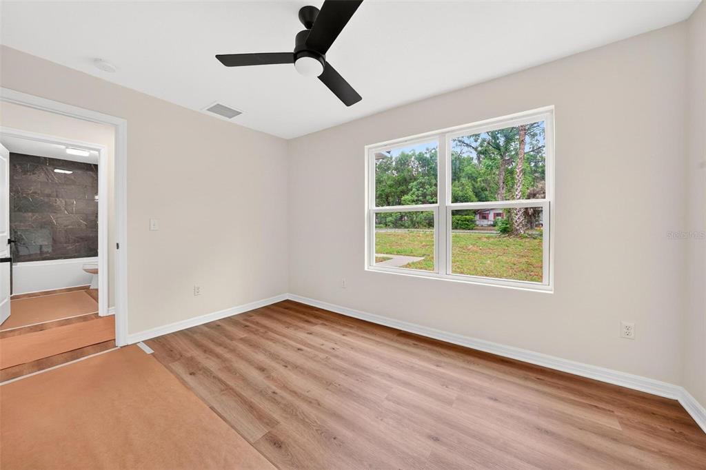 607 Thomas Avenue Leesburg, FL 34748 - Photo 36 of 50 an empty room with a window and wooden floor