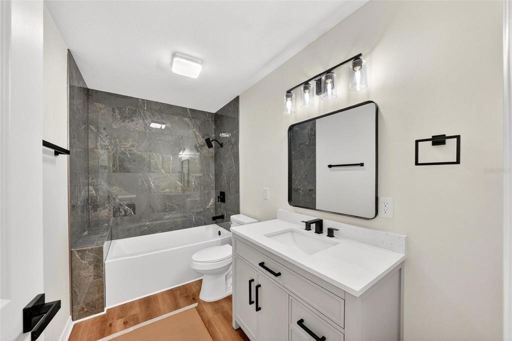607 Thomas Avenue Leesburg, FL 34748 - Photo 37 of 50 a bathroom with a sink a toilet and shower