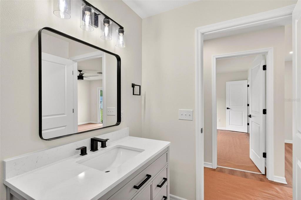 607 Thomas Avenue Leesburg, FL 34748 - Photo 38 of 50 a bathroom with a sink and a mirror