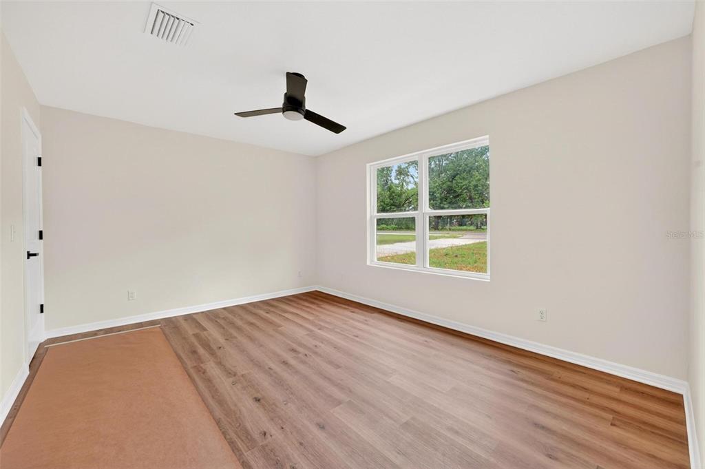 607 Thomas Avenue Leesburg, FL 34748 - Photo 39 of 50 wooden floor in an empty room with a window