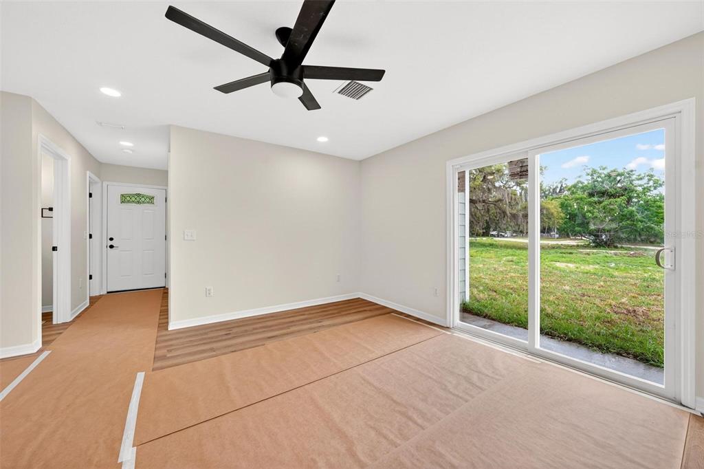 607 Thomas Avenue Leesburg, FL 34748 - Photo 42 of 50 a view of an empty room with a window and a ceiling fan