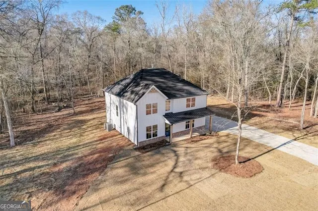 a view of a wooden house with a yard