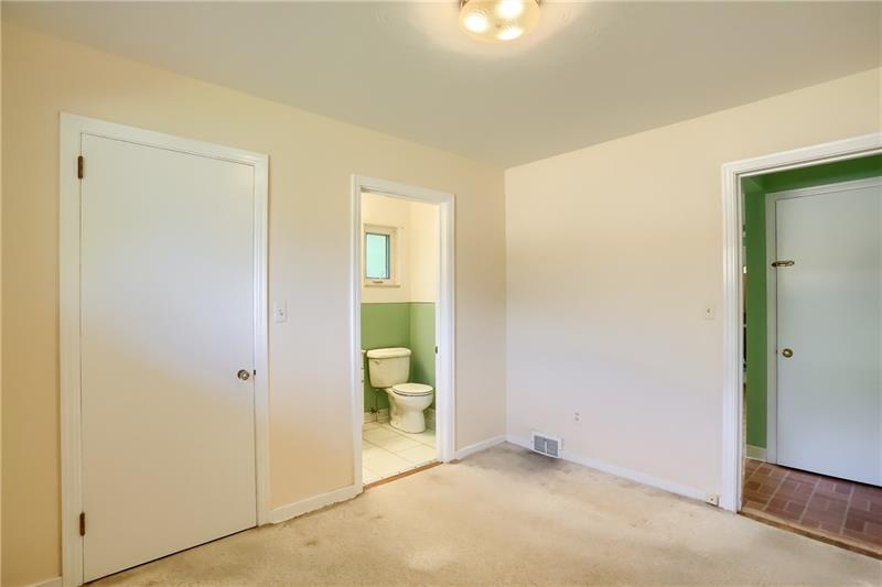 9558 Meadow Road Allison Park, PA 15101 - Photo 19 of 22 Den space off of the kitchen with 1/2 bath and large closet. This room leads you out to the screened in sunroom