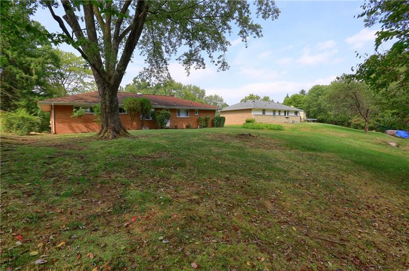 9558 Meadow Road Allison Park, PA 15101 - Photo 5 of 22 Flat yard slops down behind the home to a small wooded area