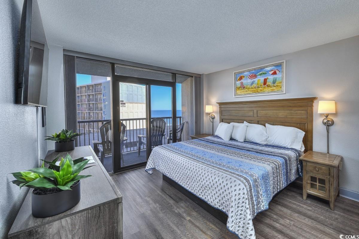 2311 South Ocean Boulevard, Unit 624 Myrtle Beach, SC 29577 - Photo 4 of 28 Bedroom with direct access to balcony, ocean view, and wood finished floors.