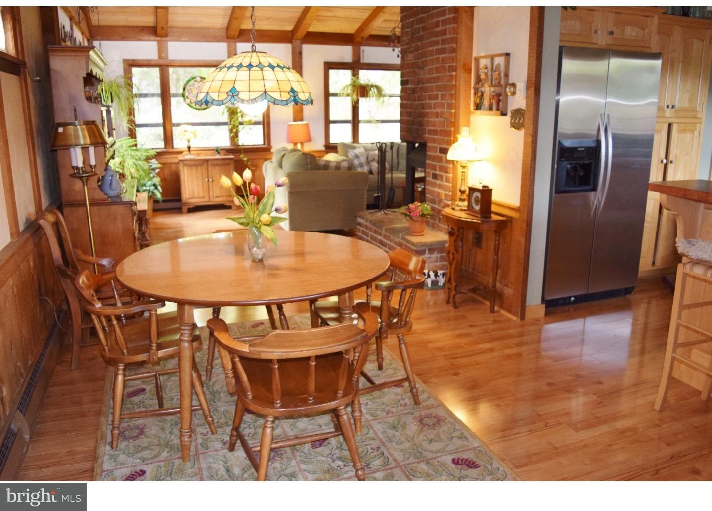 1707 Golf Road Reading, PA 19601 - Photo 8 of 17 a dining room with furniture a chandelier and wooden floor