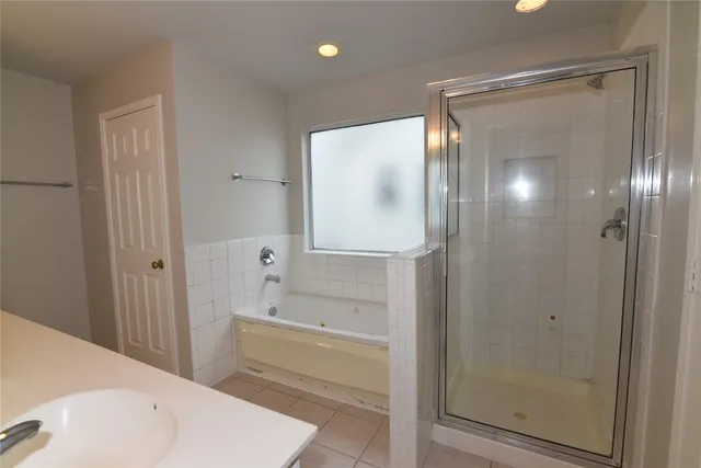 a bathroom with a bathtub and a shower