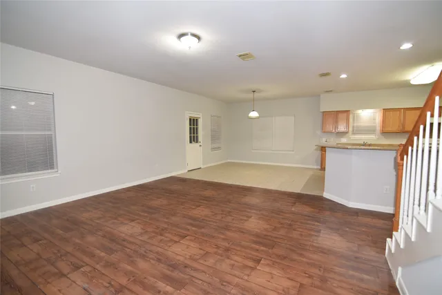 a view of a kitchen with a sink and a refrigerator