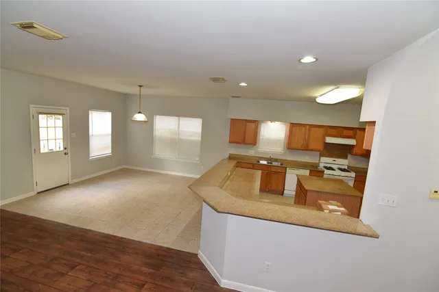 a kitchen with a stove and white cabinets