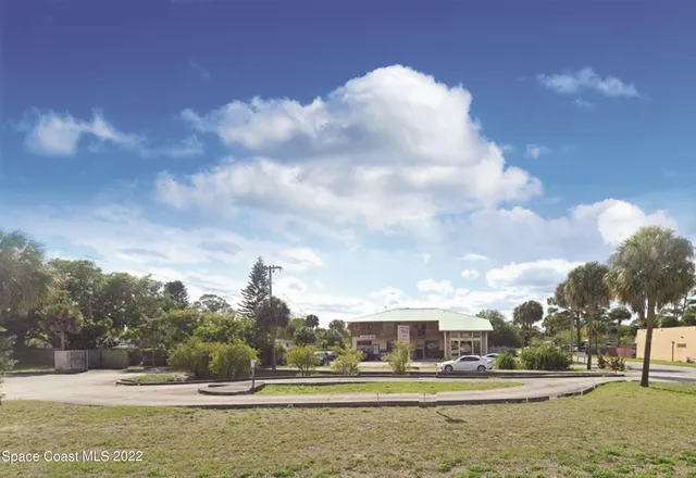 a view of swimming pool and trees in the background