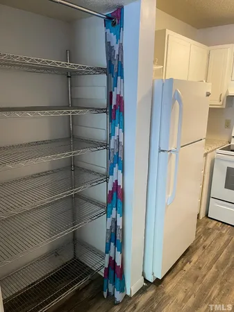 a view of a refrigerator with wooden floor