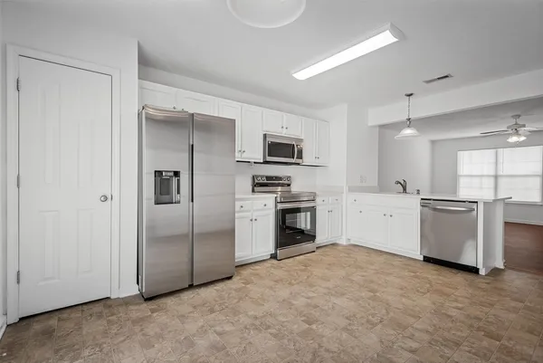 a kitchen with a refrigerator sink and stove