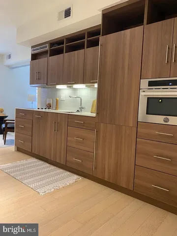 a kitchen with a refrigerator and cabinets