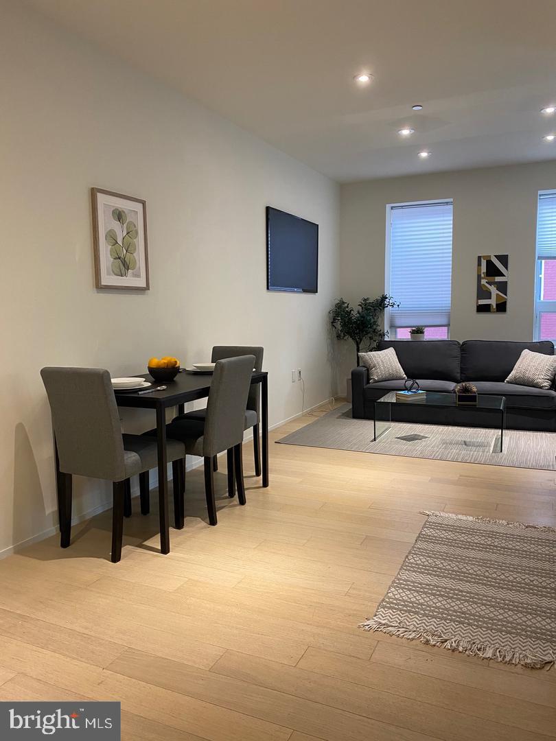 2422-2424 17th Street Northwest, Unit 207 Washington, DC 20009 - Photo 5 of 13 a living room with furniture and wooden floor