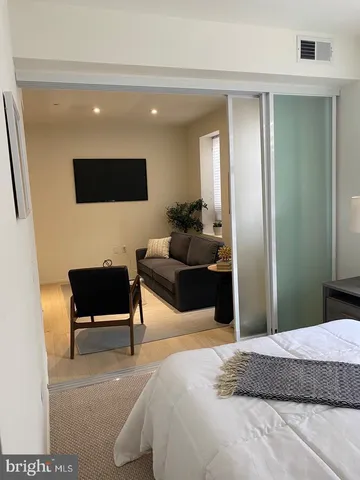 a bedroom with a bed and a couch