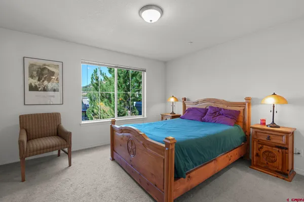 a bedroom with a bed and a lamp