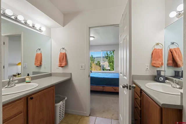 a bedroom with a bed and painting on the wall