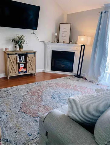a view of living room with furniture and fireplace
