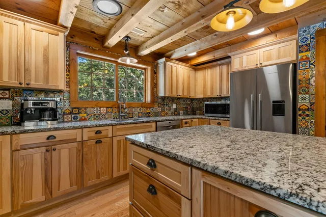 a kitchen with a stove sink and cabinets