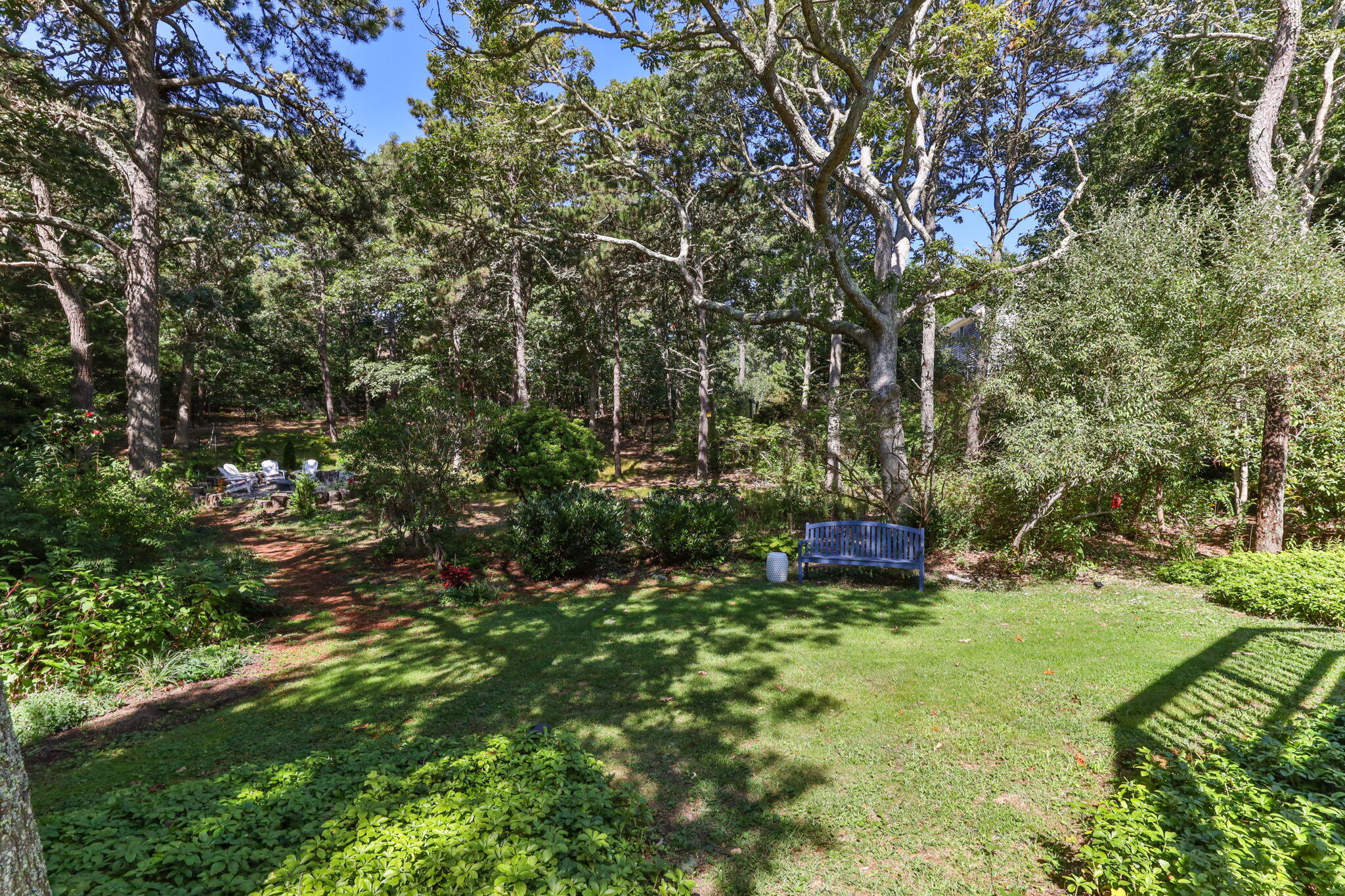 97 Round Cove Road Chatham, MA 02633 - Photo 44 of 55 a view of a garden with a bench