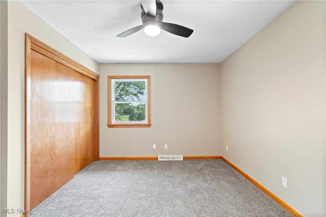 1716 Betz Road Akron, OH 44306 - Photo 14 of 28 Unfurnished bedroom featuring a closet, carpet flooring, and a ceiling fan