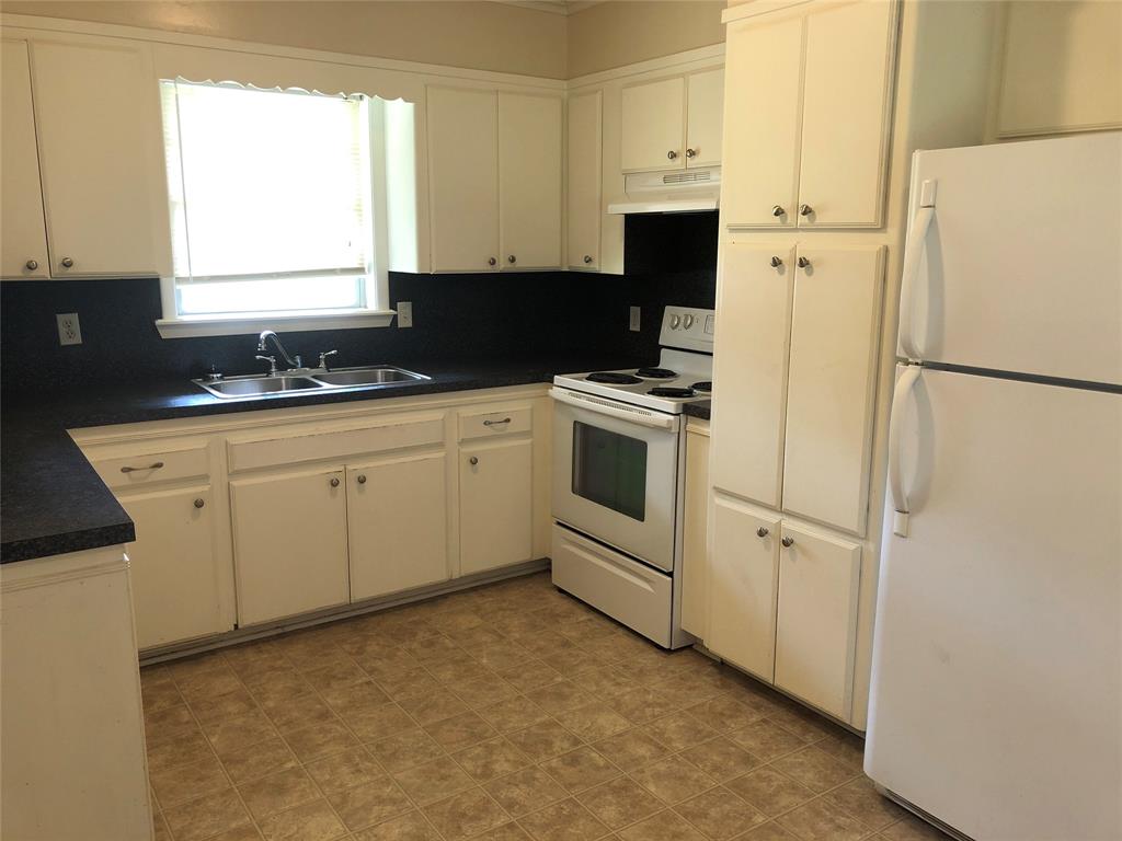 2722 Bolch Street Shreveport, LA 71104 - Photo 2 of 13 a kitchen with stainless steel appliances a refrigerator sink and white cabinets