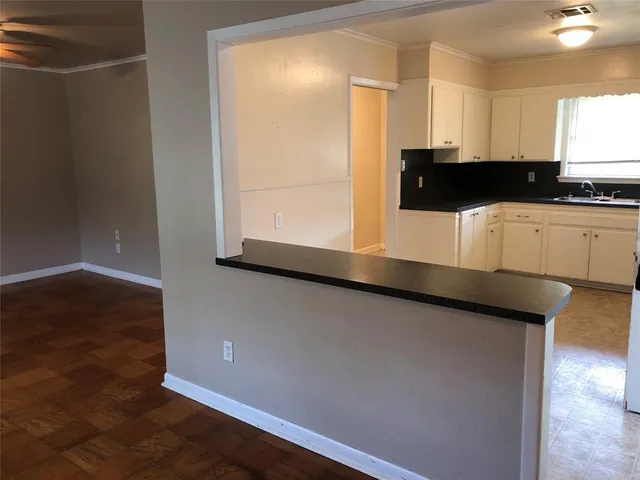 a view of a kitchen with wooden floor