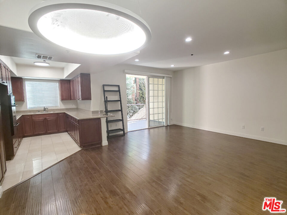 962 Gramercy Drive, Unit 102 Los Angeles, CA 90019 - Photo 3 of 20 a view of a kitchen with a sink and a large mirror