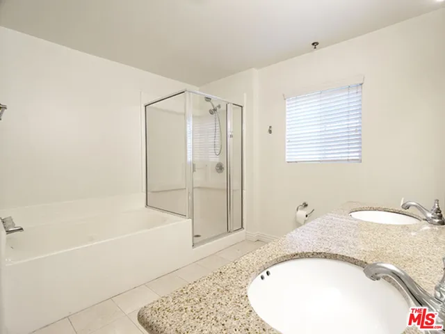 a bathroom with a granite countertop bathtub and a sink