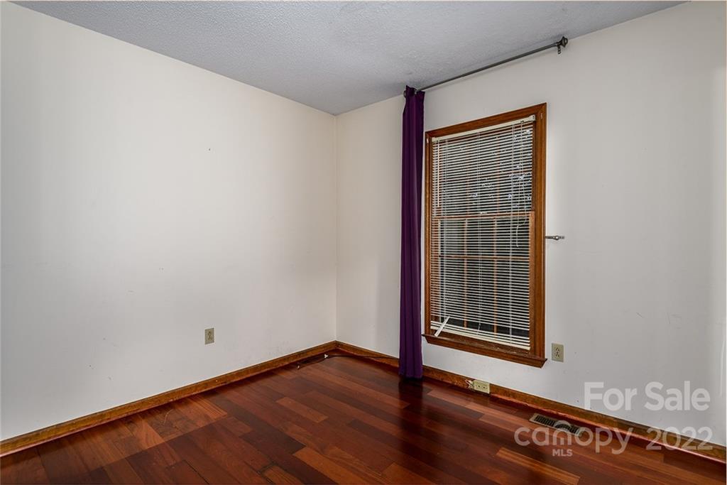 6199 Timberlane Terrace Hickory, NC 28601 - Photo 12 of 20 a view of an empty room with wooden floor and a window