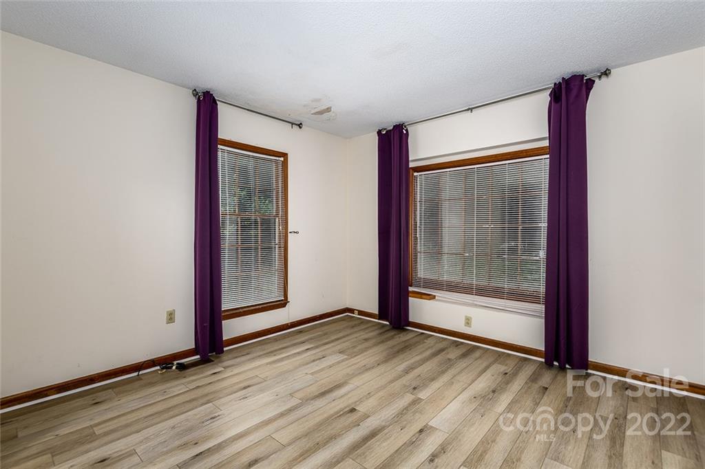 6199 Timberlane Terrace Hickory, NC 28601 - Photo 15 of 20 a view of an empty room with wooden floor and a window