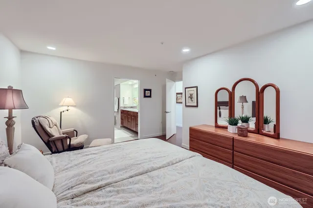 a bathroom with a sink double vanity granite tub shower and a mirror