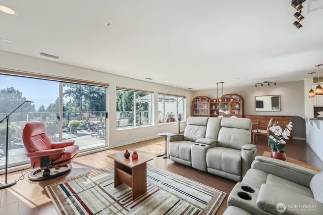 a living room with furniture a table and a large window