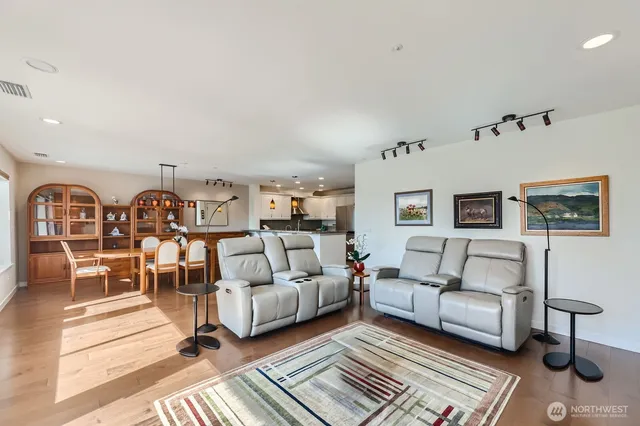 a living room with furniture a rug and a table