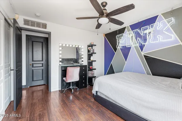 a bedroom with a bed and a workspace