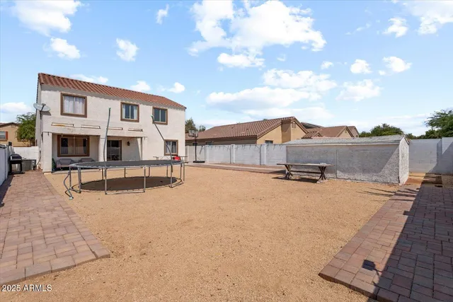 a swimming pool with outdoor seating and yard