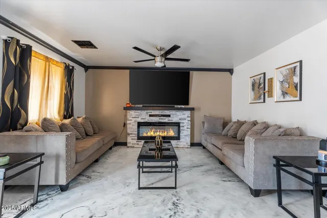 a living room with furniture a flat screen tv and a fireplace
