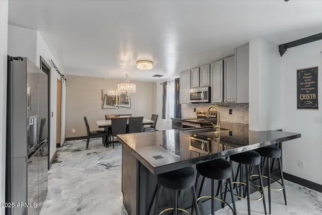 a view of kitchen with cabinets table and chairs