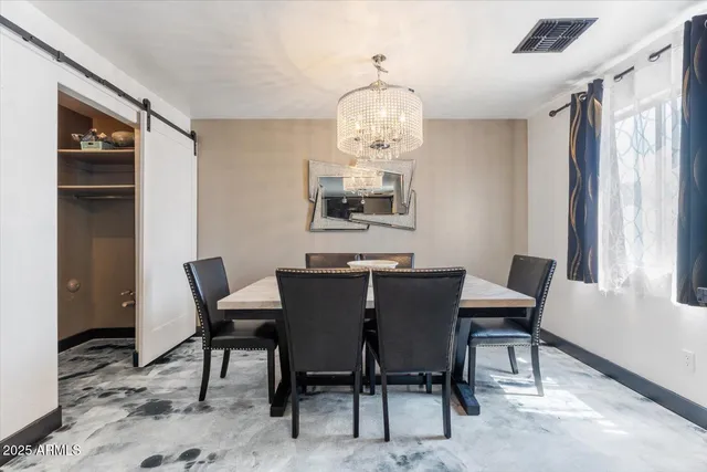 a view of a dining room with furniture wooden floor and chandelier