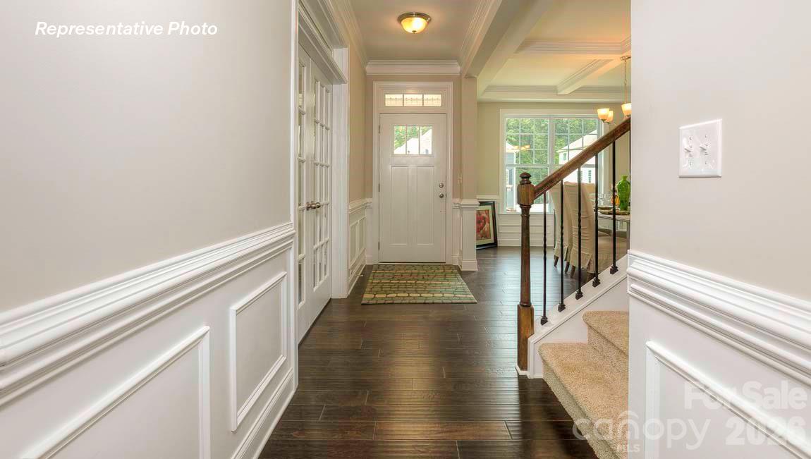 3003 Eclipse Court Indian Trail, NC 28079 - Photo 2 of 48 a view of a hallway with wooden floor and staircase