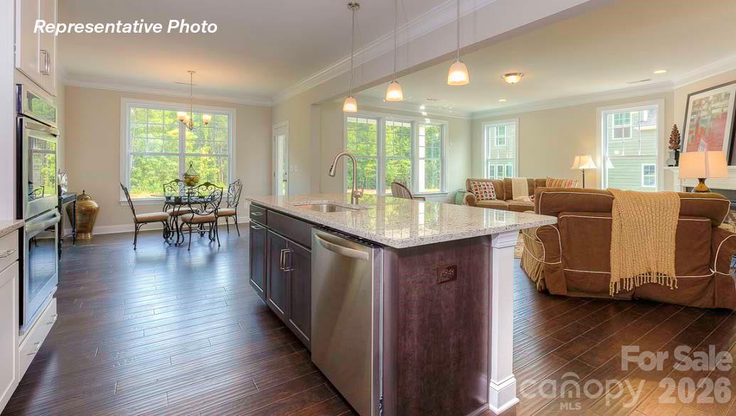 3003 Eclipse Court Indian Trail, NC 28079 - Photo 23 of 48 a dining hall with couches wooden floor and a dining table with wooden floor