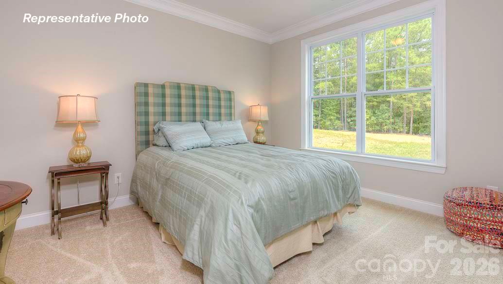 3003 Eclipse Court Indian Trail, NC 28079 - Photo 28 of 48 a bedroom with a bed and a lamp next to a window