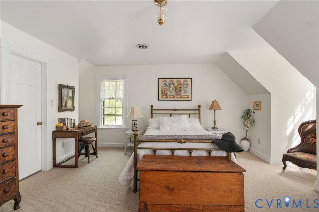 7381 McClellan Road Mechanicsville, VA 23111 - Photo 52 of 66 a bedroom with a bed and a lounge chair